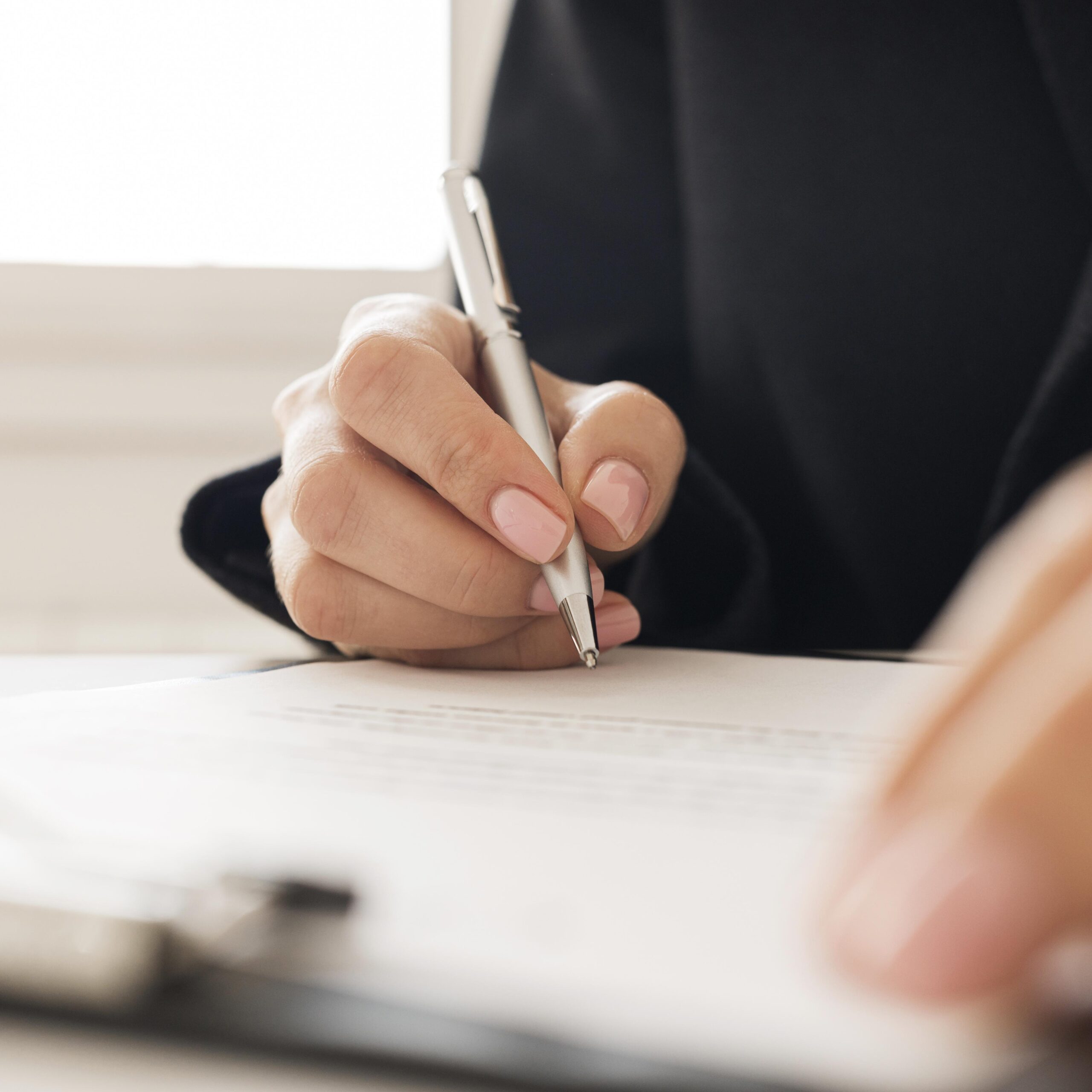close-up-person-signing-certificate-scaled-1.jpg